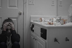 woman-stressed-pills-bathroom